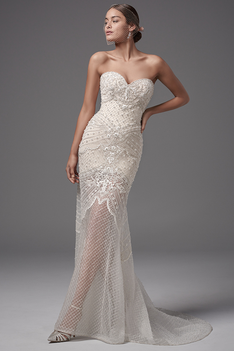 This stunning tulle fit-and-flare features exquisite bead and pearl crosshatch detailing. Complete with strapless sweetheart neckline and short Rivie jersey lining creating an illusion skirt. Finished with zipper over inner elastic closure. An illusion capelet accented with beaded lace appliqués, crosshatching, and Swarovski crystals sold separately. 
<a href="https://www.maggiesottero.com/sottero-and-midgley/annika-leigh/10208?utm_source=mywedding.com&amp;utm_campaign=spring17&amp;utm_medium=gallery" target="_blank">Sottero and Midlgey</a>