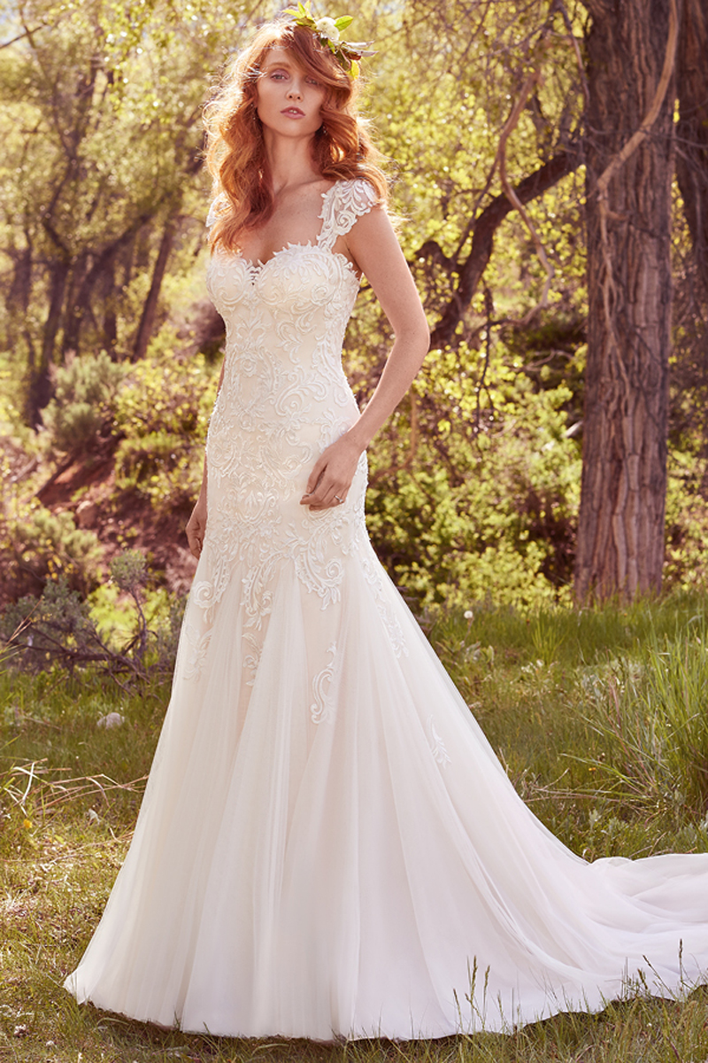 Striking lace appliqués adorn the bodice of this romantic fit-and-flare, featuring a sweetheart neckline and godets in the airy tulle and English netting skirt. Finished with covered buttons over zipper and inner elastic closure. Detachable cap-sleeves with lace appliqués sold separately.  
<a href="https://www.maggiesottero.com/maggie-sottero/perla/10130?utm_source=mywedding.com&amp;utm_campaign=spring17&amp;utm_medium=gallery" target="_blank">Maggie Sottero</a>