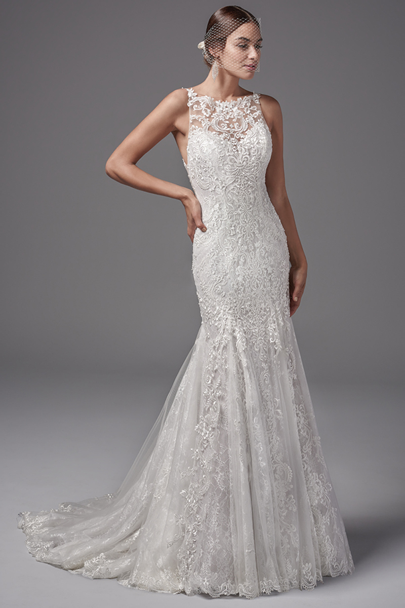 Apresentando várias camadas de renda, este modelo fit-and-flare evoca um romance sofisticado. Alças elegantes confeccionadas, também, com renda que completam o efeito de coração no decote, realçando as costas, enquando que o tule e as linhas de renda caem fluenemente para a impressionante saia. Terminado com botões e um fecho.
<a href="https://www.maggiesottero.com/sottero-and-midgley/juno/10233?utm_source=mywedding.com&utm_campaign=spring17&utm_medium=gallery" target="_blank">Sottero and Midgley</a>