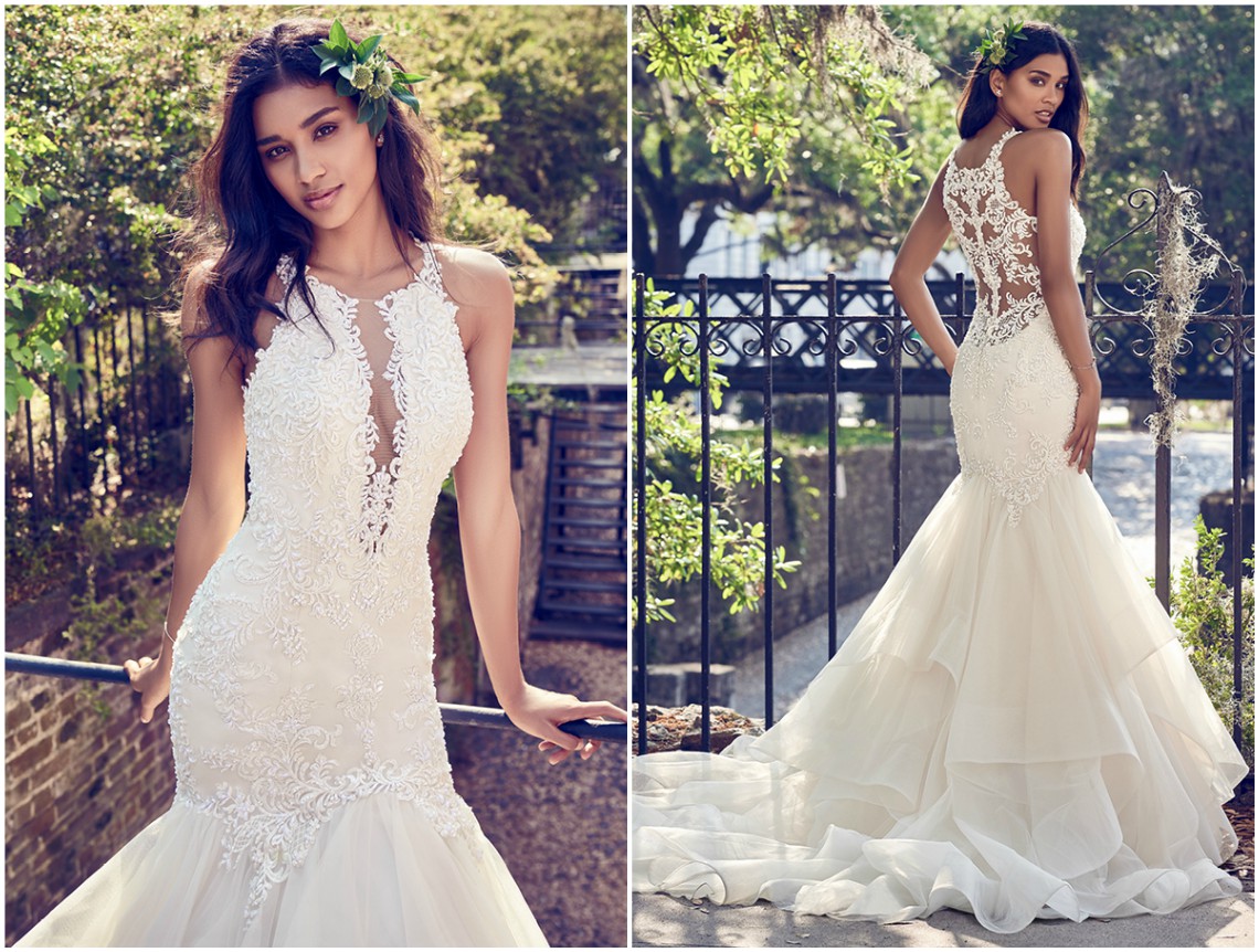 Renda com pedraria e cristais Swarovski adornam o corpo, as costas ilusão e pescoço halter com um profundo decote em V. A saia em tule e organza em crina completa este vestido de noiva com silhueta fit-and-flare. Acabamentos com botões de cristal sobre fecho zíper. <a href="https://www.maggiesottero.com/maggie-sottero/veda/11197?utm_source=zankyou&utm_medium=gowngallery" target="_blank">Maggie Sottero</a>