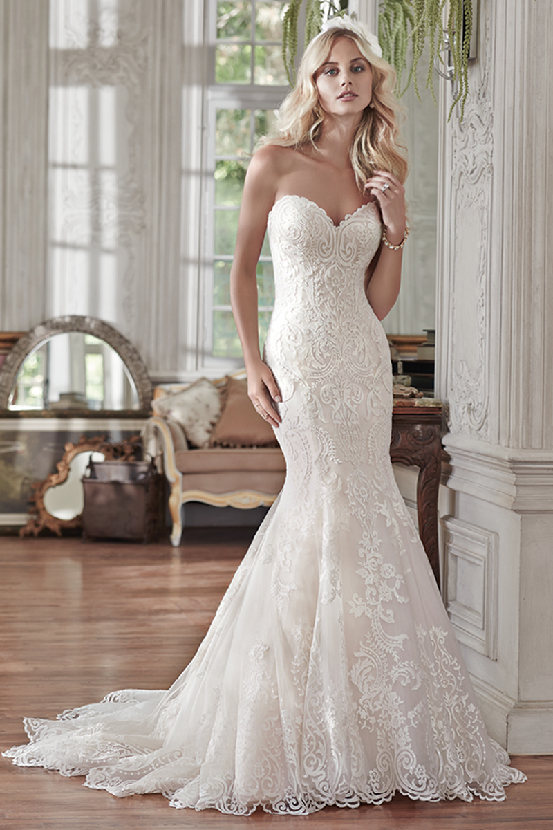 Lovely in lace, this fit and flare wedding dress is the epitome of beauty with bold lace appliqués laying atop tulle, cascading to a subtly flared skirt. Finished with sweetheart neckline and corset closure. Detachable lace cap-sleeves sold separately.
<a href="www.maggiesottero.com/maggie-sottero/rosamund/9524" target="_blank">Maggie Sottero</a>
