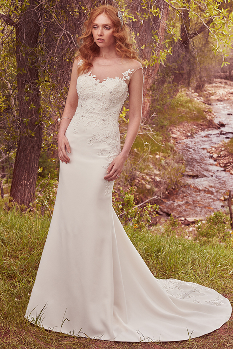 A maravilhosa baínha que o vestido exibe apresenta um corpete embelezado com renda e com pérolas delicadas e cristais Swarovski. Um decote em forma de coração. Terminado com botões na zona do fecho.
<a href="https://www.maggiesottero.com/maggie-sottero/dion/10097?utm_source=mywedding.com&utm_campaign=spring17&utm_medium=gallery" target="_blank">Maggie Sottero</a>
