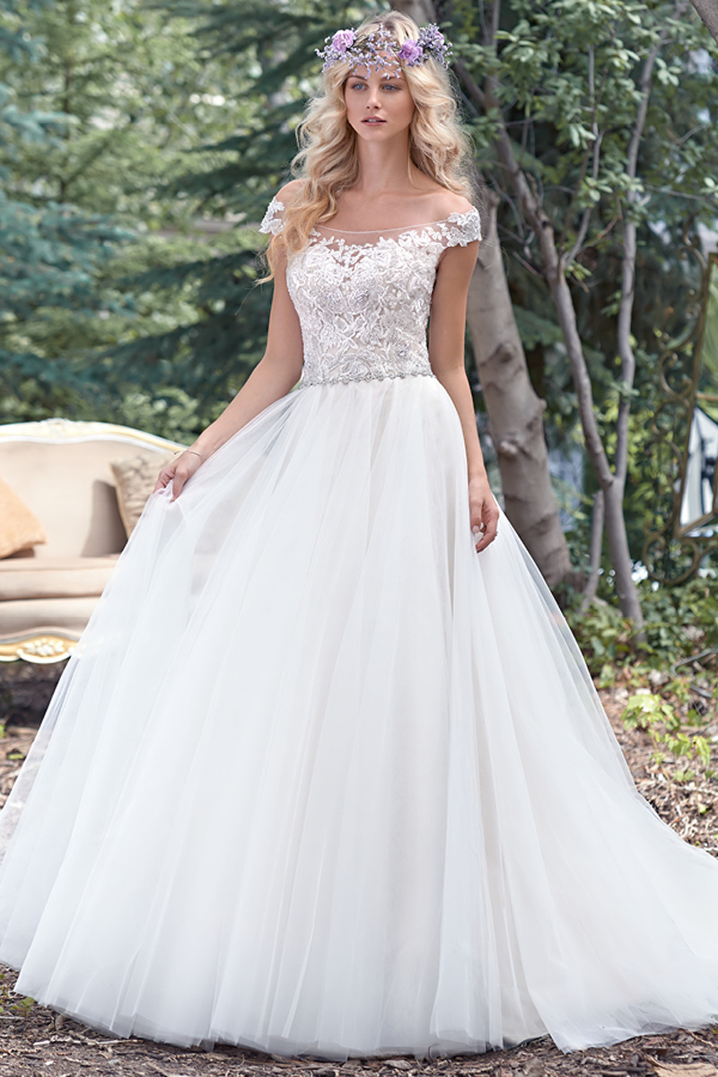 A delicate illusion off-the-shoulder neckline coupled with a dramatic illusion lace back create glamour in this alluring ball gown wedding dress with delicate lace bodice and flowing tulle skirt, accented with a feminine Swarovski crystal belt. Finished with crystal button over zipper closure.
<a href="www.maggiesottero.com/maggie-sottero/montgomery/9492" target="_blank">Maggie Sottero</a>