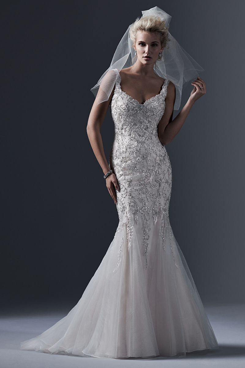 Detalhes de renda bordados neste vestido de cetim com cristais Swarovski enfeitam o tule fit-and-flare, com um decote em U atrevido nas costas e um decote romântico em forma de coração na parte da frente. Terminado com botões de cristal em vez do fecho.
<a href="http://www.sotteroandmidgley.com/dress.aspx?style=5SB628&page=0&pageSize=36&keywordText=&keywordType=All" target="_blank">Sottero and Midgley</a>