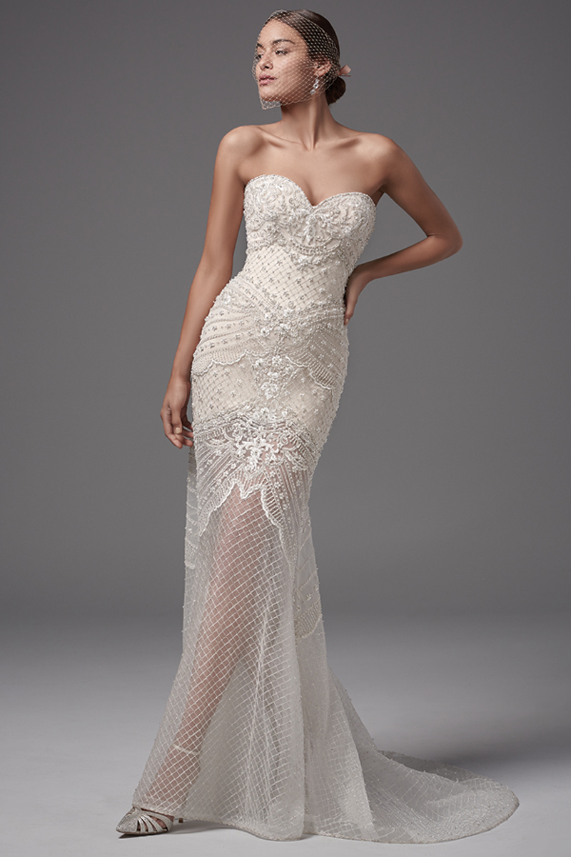This stunning tulle fit-and-flare features exquisite bead and pearl crosshatch detailing. Complete with strapless sweetheart neckline and short Rivie jersey lining creating an illusion skirt. Finished with zipper over inner elastic closure. An illusion capelet accented with beaded lace appliqués, crosshatching, and Swarovski crystals sold separately.
<a href="https://www.maggiesottero.com/sottero-and-midgley/annika-leigh/10208?utm_source=mywedding.com&utm_campaign=spring17&utm_medium=gallery" target="_blank">Sottero and Midlgey</a>