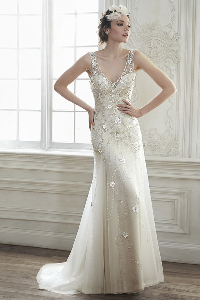 Este modelo é a combinação perfeita de elegância e romance. O tule combina-se com aplicações tridimensionais florais e cristais de Swarovski com as mangas em malha ilusão. Acabamento com coberta de botões de cristal sobre o fecho zipper.
<a href="http://www.maggiesottero.com/dress.aspx?style=5MT024" target="_blank">Maggie Sottero Spring 2015</a>