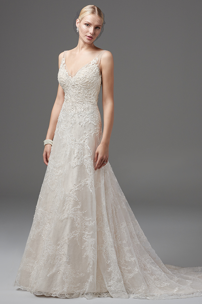 Camadas de renda bordadas que caem em cascata ao longo de um camada confeccionada totalmente com renda caracterizam este luxuoso vestido Linha-A. Com um decote em V, quer na parte da frente quer na de trás. As baínhas e costuras apresentam pérolas e lantejoulas brilhantes que evocam um glamour inagualável.
<a href="https://www.maggiesottero.com/sottero-and-midgley/cecilia/10212?utm_source=mywedding.com&utm_campaign=spring17&utm_medium=gallery" target="_blank">Sottero and Midgley</a>
