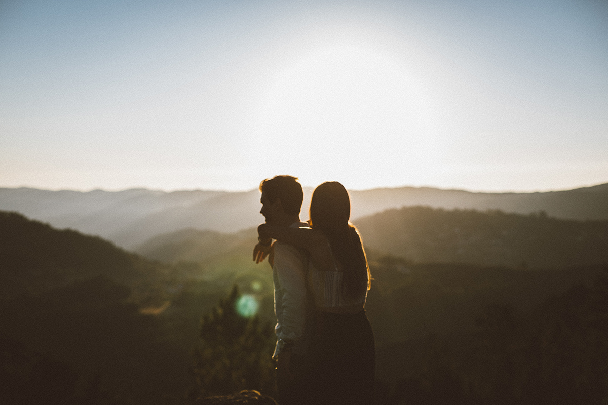 casal abraçado ao por-do-sol