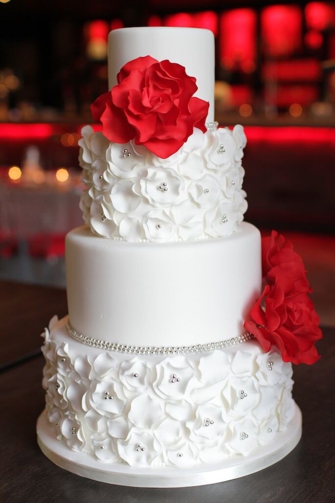 Bolo de casamento - um dos protagonistas da festa - com detalhes em vermelho.