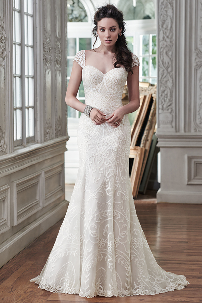 Timeless and classic, this slim A-line wedding dress is the epitome of beauty with romantic lace and an alluring sweetheart neckline. Available with corset closure or covered button over zipper closure. Detachable cap-sleeves sold separately.
<a href="https://www.maggiesottero.com/maggie-sottero/mirian/9488" target="_blank">Maggie Sottero</a>