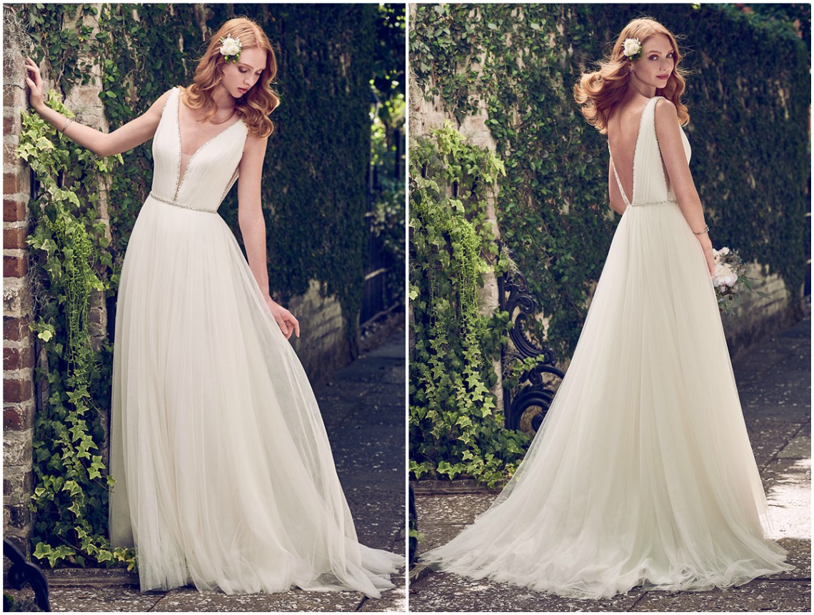 Vestido linha A inspirado nos modelos gregos, com volumosas camadas de tule com pedraria e cristais Swarovski ao longo do decote profundo ilusão, na cintura, nas alças e no decote em V nas costas. Acabamento com fecho zíper. <a href="https://www.maggiesottero.com/maggie-sottero/tamar/11194?utm_source=zankyou&utm_medium=gowngallery" target="_blank">Maggie Sottero</a>