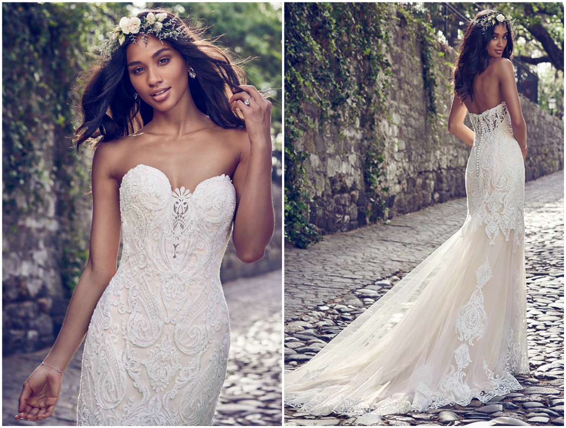 Vestido de noiva fit-and-flare de renda com pedrarias sobre tule, que acentuam a ilusão do profundo decote coração e do decote ilusão nas costas. Acabamentos com botões forrados sobre fecho zíper.
<a href="https://www.maggiesottero.com/maggie-sottero/autumn/11153?utm_source=zankyou&utm_medium=gowngallery" target="_blank">Maggie Sottero</a>