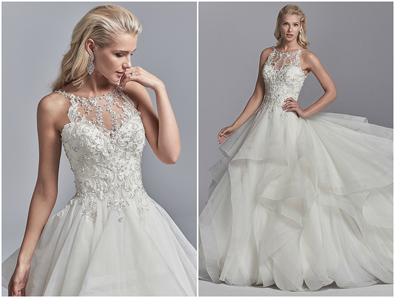 Cintilantes aplicações em renda, com missangas e cristais Swarovski a cair em cascata sobre o corpo deste vestido de noiva corte princesa, que fica completo com um efeito ilusão halter sobre decote coração e costas nuas. Saia de tule em camadas. Acabamentos com botões de cristal sobre fecho de correr.
<a href="https://www.maggiesottero.com/sottero-and-midgley/murphy/11219?utm_source=zankyou&utm_medium=gowngallery" target="_blank">Sottero and Midgley</a>