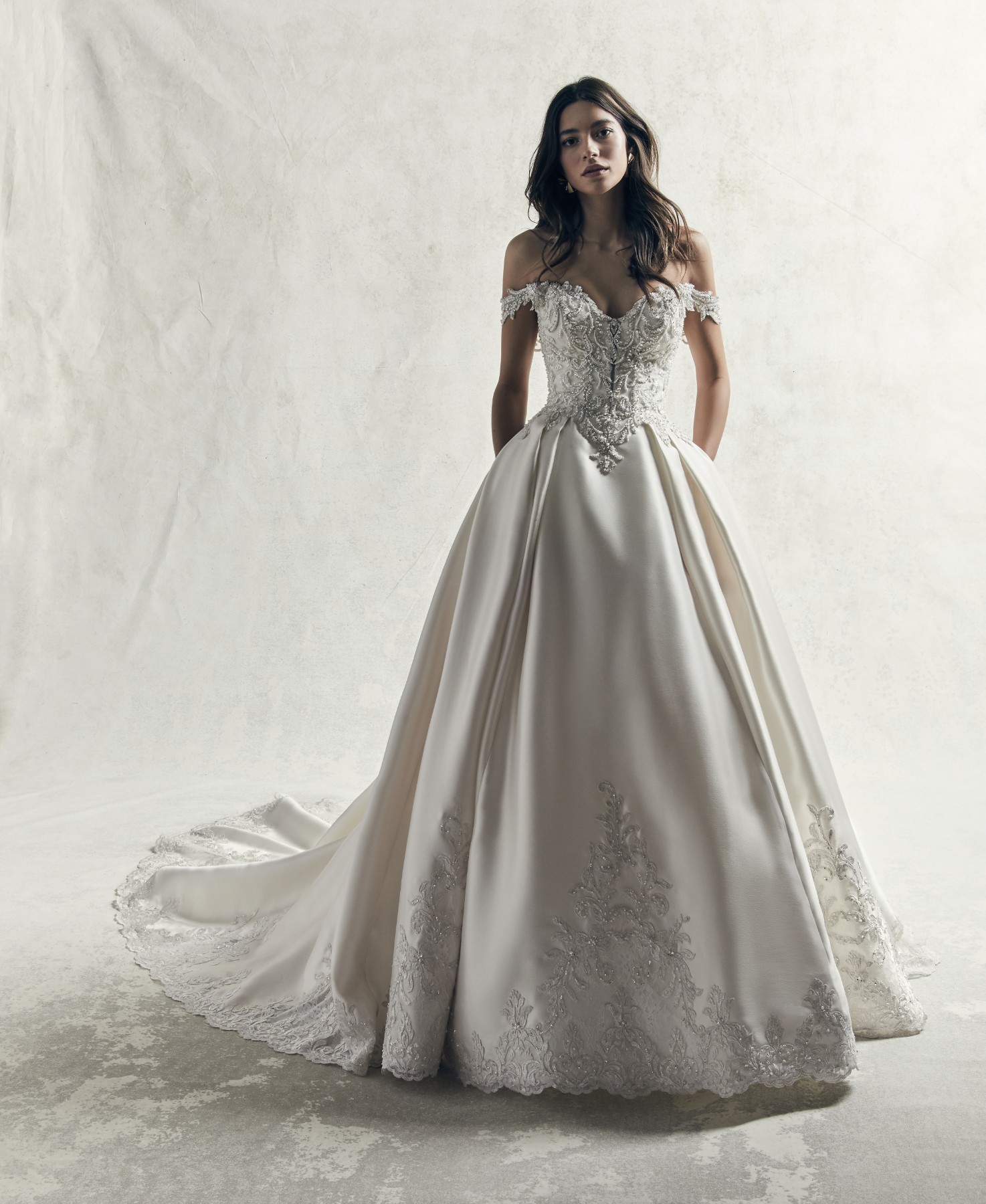 Este vestido de noiva apresenta a fusão perfeita entre o romance vintage e a elegância moderna, ao apresentar renda bordada no seu body sobre um saia de baile, confecionada com Mikado Elodie.