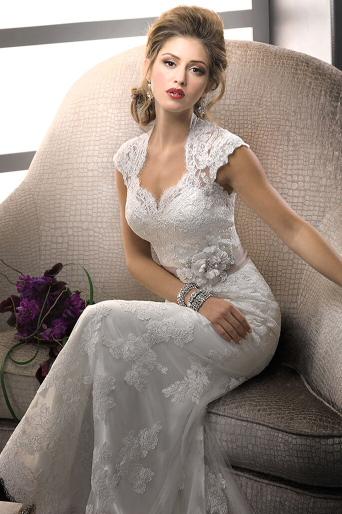 Romance e conforto esperam ser descobertos neste elegante vestido de renda com decote e mangas delicadas, que está sobreposto a um slip dress de cetim Royal desenhado para ser usado por baixo. Este confortável slip dress contorna o corpo proporcionando um caimento perfeito. Disponível com um diferenciado cinto de fita de gorgorão com um broche de cristal Swarovski ou com exclusivas flores feitas à mão. Fechamento com botões forrados.
<a href="http://www.sotteroandmidgley.com/dress.aspx?style=71723" target="_blank">Sottero & Midgley Platinum 2015</a>